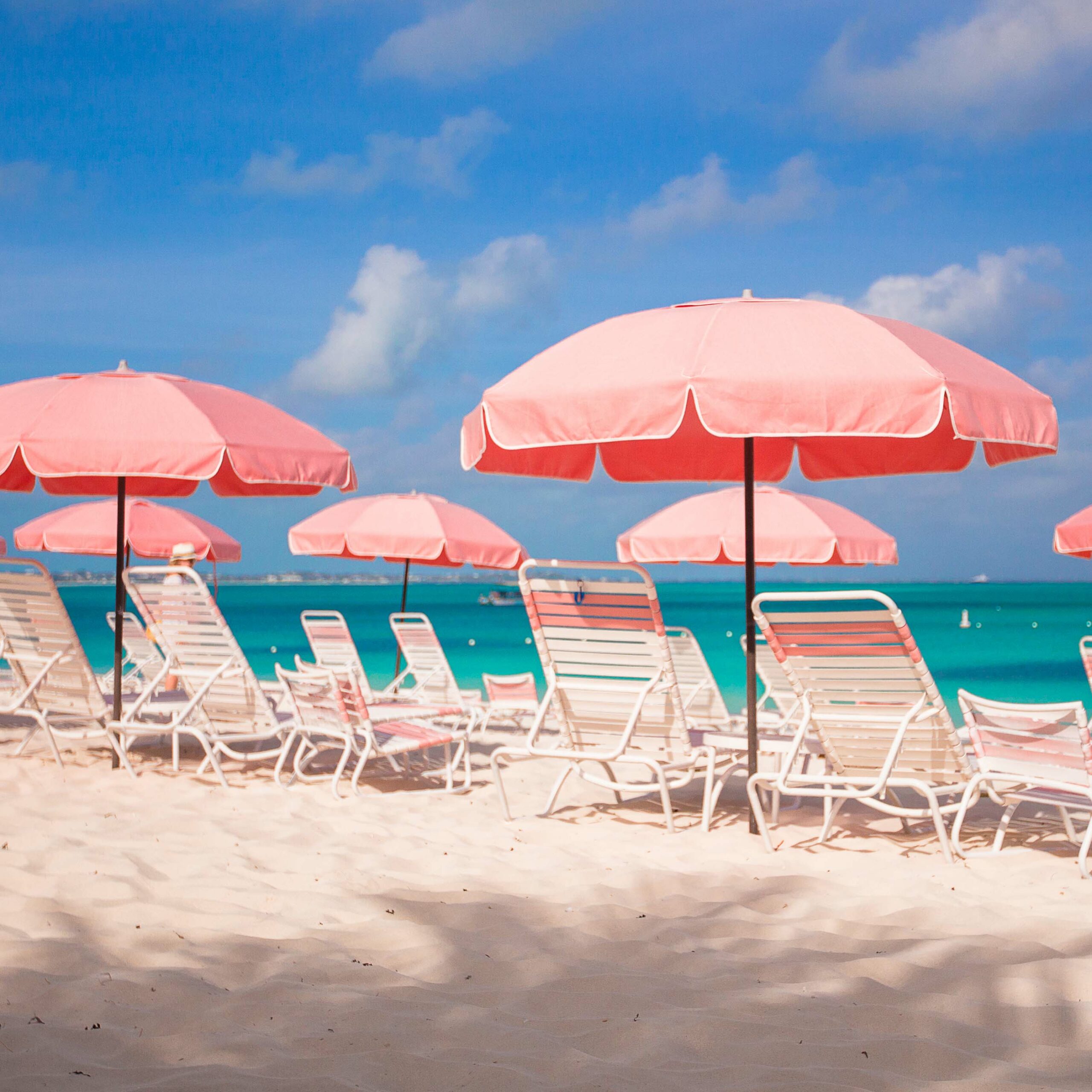 White umbrella at tropical beach background blue sea